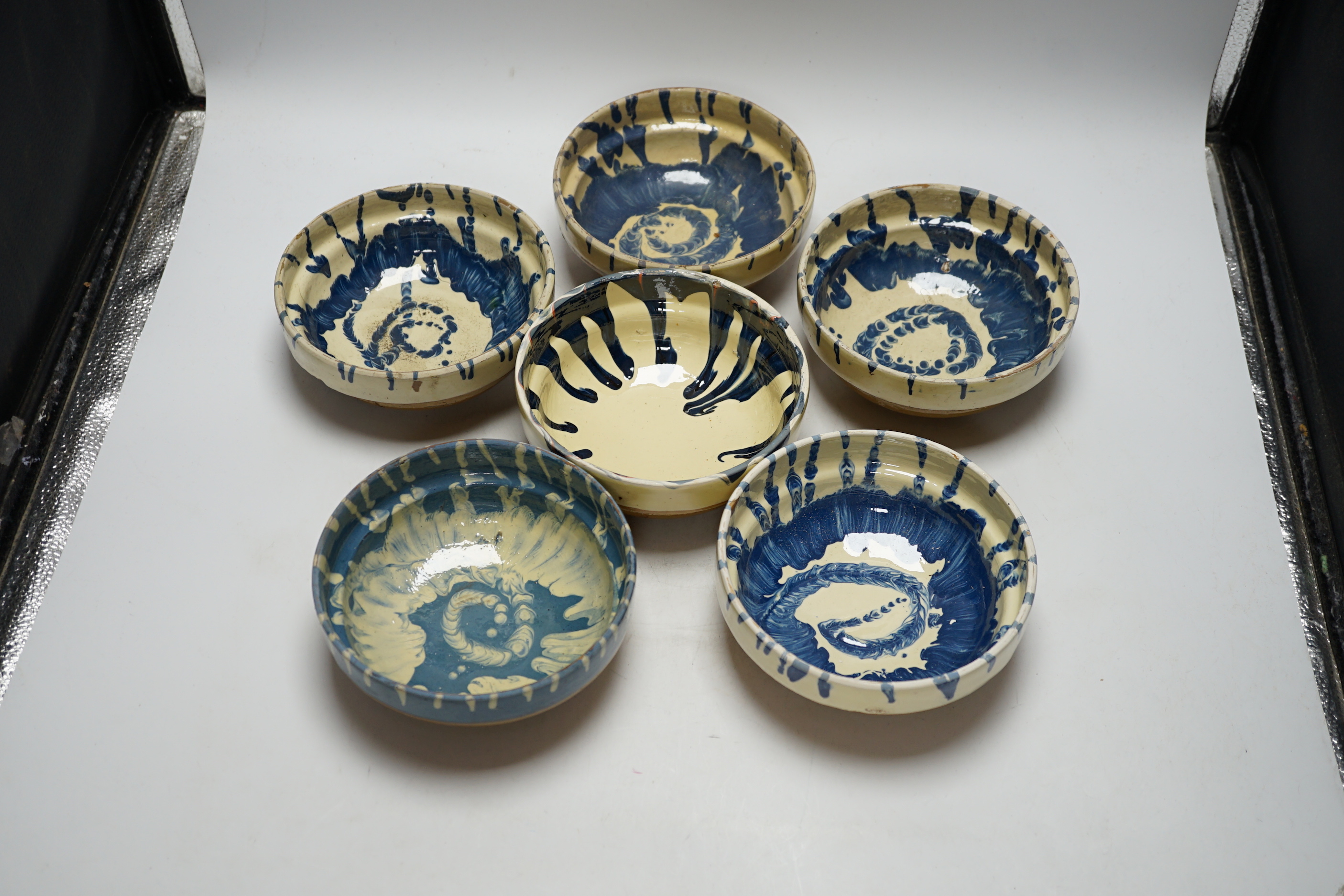 A group of six slipware pottery bowls, 16cm